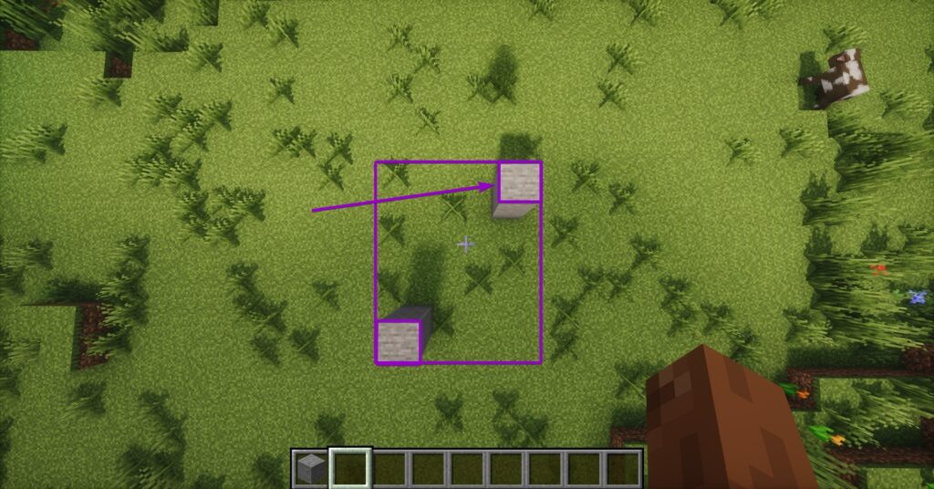 Top-down view showing an arrow pointing to the first corner pillar of a designated build area