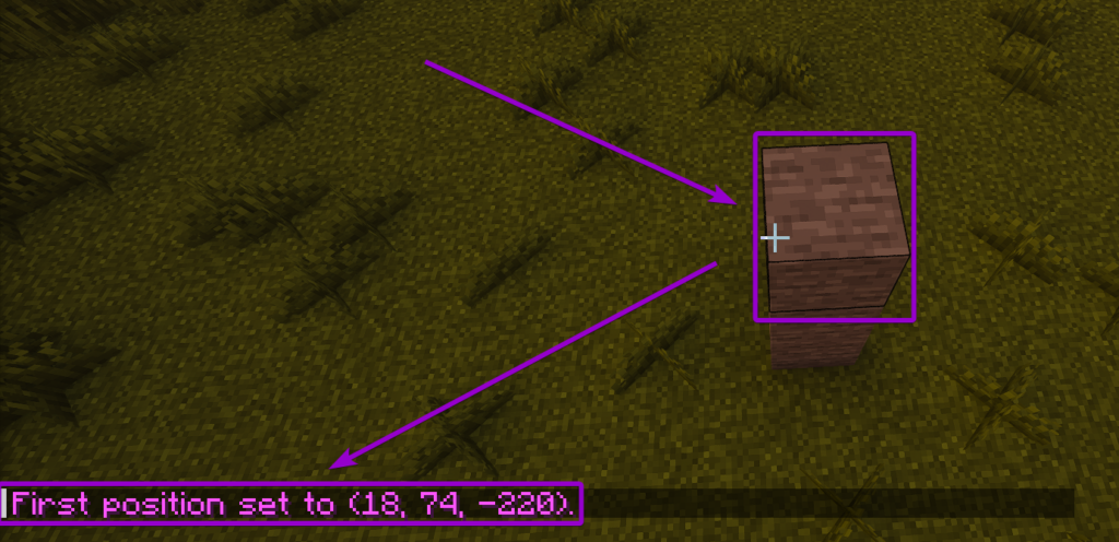 Left-clicking a block with the WorldEdit wand to set the first position, with the chat confirmation highlighted
