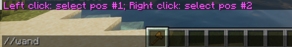 A Minecraft player typing the //wand command to receive the wooden axe selection tool